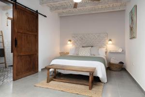 a bedroom with a bed and a wooden door at Apartamento Romero in Arrecife