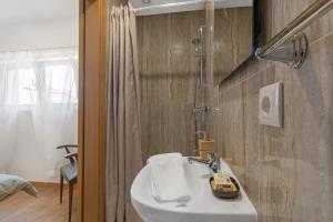 a bathroom with a white sink and a shower at Refúgio de Fátima in Fátima +68 photos