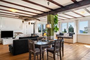 a living room with a table and chairs and a couch at Augensteins Burgzimmer in Seelbach