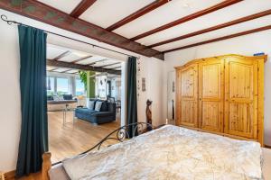 a bedroom with a bed and a living room at Augensteins Burgzimmer in Seelbach