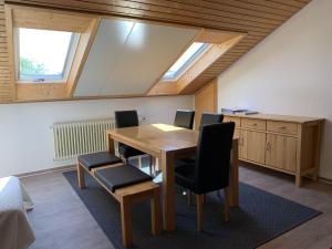 an attic office with a wooden table and chairs at Ferienwohnung Käppeler in Salem