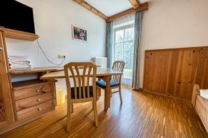 a dining room with a table and two chairs at Lindenhof Apt 7 in Vandoies