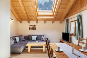 a living room with a couch and a table at Apartment Ferienhaus Huber in Grainau