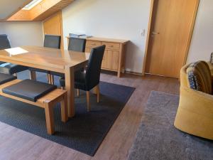 a conference room with a wooden table and chairs at Ferienwohnung Käppeler in Salem