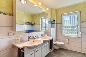 a bathroom with two sinks and a toilet at Im Rosengarten in Zell am Harmersbach +17 photos