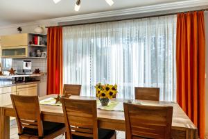 a kitchen with a dining room table and a large window at Im Rosengarten in Zell am Harmersbach
