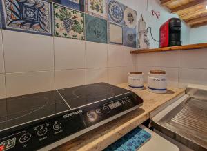 a kitchen with a counter with a stove top at Il Borgo 5 in Capoliveri