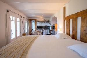 a bedroom with a large bed and a dining room at La Maison de Constance in Cavalaire-sur-Mer
