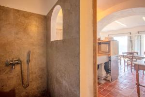 a bathroom with a walk in shower and a kitchen at La Maison de Constance in Cavalaire-sur-Mer +10 photos