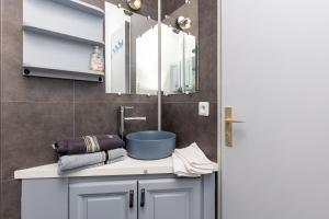a bathroom with a sink and a mirror at Location Noly in Seignosse +17 photos