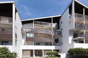 an apartment building with balconies on the side at Location Noly in Seignosse
