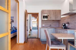 a kitchen with a table and a dining room at Ferienwohnung 3 Weger in Andrian