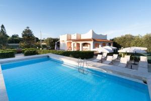 a swimming pool in front of a villa at Villa Leale Plemmirio con piscina in Syracuse