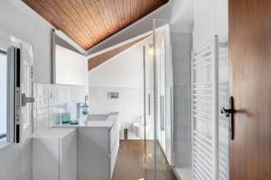 a bathroom with a sink and a toilet at Attico Con Vista in Moneglia +17 photos