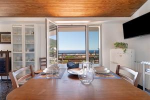 a dining room table with a view of the ocean at Attico Con Vista in Moneglia
