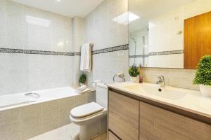 a bathroom with a toilet and a sink and a tub at Daniela in Pollença +18 photos