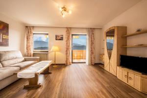 a living room with a couch and a table at Residence Kronstein - Fewo 6 in Tesimo