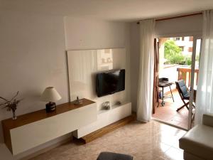 a living room with a television on a wall at Apartament a Sant Antoni de Calonge in Calonge