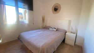 a small bedroom with a bed and a window at Apartament a Sant Antoni de Calonge in Calonge +21 photos