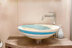 a bowl sink sitting on a counter in a bathroom at Weingut Lieselehof Apt Aurora in Caldaro +8 photos