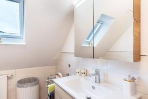 a bathroom with a sink and a mirror at Furtwengler in Oberharmersbach +24 photos