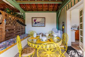 a dining room with a yellow table and chairs at La Chambre Dorée du Bassin in La Teste-de-Buch