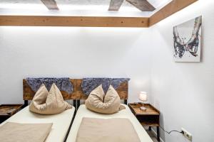 a bedroom with a bed with two pillows at im Fachwerk in Alsfeld