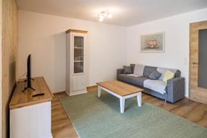 a living room with a couch and a table at Ferienwohnung Häfele 2 in Bad Wurzach