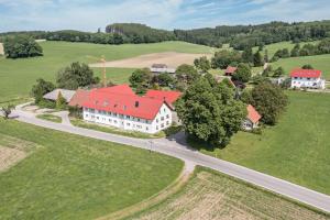 an aerial view of a large white house with a red roof at Ferienwohnung Häfele 2 in Bad Wurzach
