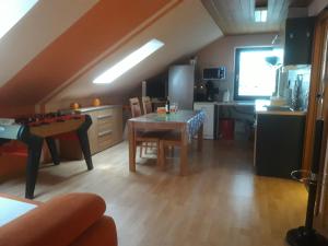 a living room with a table and a kitchen at Schwäbische Alb in Gomadingen