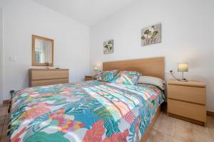 a bedroom with a bed with a colorful bedspread at Traditional Villa in Creixell +21 photos