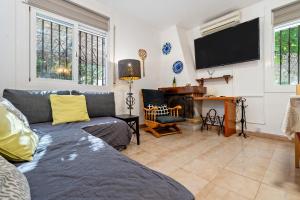 a living room with a couch and a flat screen tv at Traditional Villa in Creixell