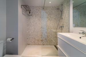 a bathroom with a shower with a toilet and a sink at 2bed apartment in Miraflores in Mijas +17 photos