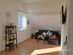 a living room with a couch and a chair at Im Grünen 2 in Weil der Stadt