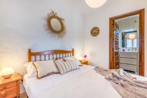 a bedroom with a bed and a mirror on the wall at El Horreo Xabia in El Tosalet +33 photos