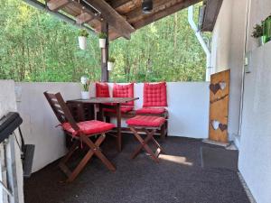 a patio with a wooden table and chairs at Im Grünen 2 in Weil der Stadt