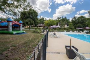 a pool at a resort with a slide at Mobilhome Le Chene in Saint-Pompont +15 photos