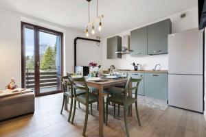a kitchen and dining room with a table and chairs at A Casa Mia Prada vacanza di relax in Prada