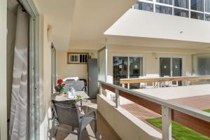 a balcony of a house with a table and a chair at Kellys' Apartment Las Camelias in San Bartolomé