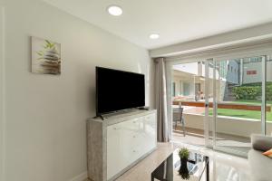 a living room with a flat screen tv on a wall at Kellys' Apartment Las Camelias in San Bartolomé