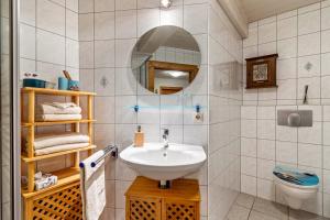 a bathroom with a sink and a toilet at Ferienwohnung Brandenkopf in Oberharmersbach +10 photos