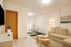 a living room with a couch and a table at Little Gem in Cruce de Arinaga