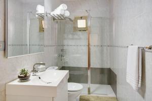a bathroom with a shower and a toilet and a sink at Little Gem in Cruce de Arinaga +12 photos