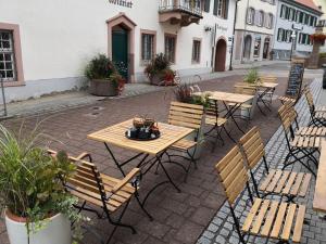 a group of tables and chairs on a patio at Ferienwohnung Gugel, 48qm in Kandern +10 photos