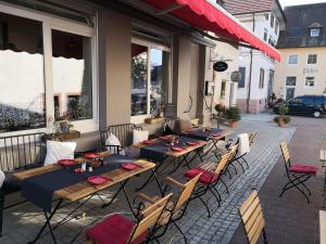 a group of tables and chairs on a patio at Ferienwohnung Gugel, 48qm in Kandern