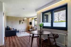 a living room with a table and a window at Ferienwohnung Reichle in Stockach