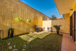 a side of a building with a yard at Casa Celeste in Villasimius