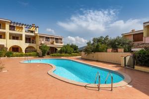 a swimming pool in front of a building at Casa Celeste in Villasimius