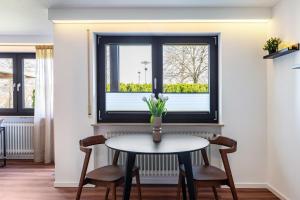 a table and chairs in a room with a window at Ferienwohnung Reichle in Stockach +14 photos