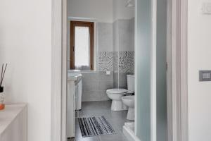 a white bathroom with a toilet and a sink at Chalet La Greta con vista in Firenzuola +14 photos